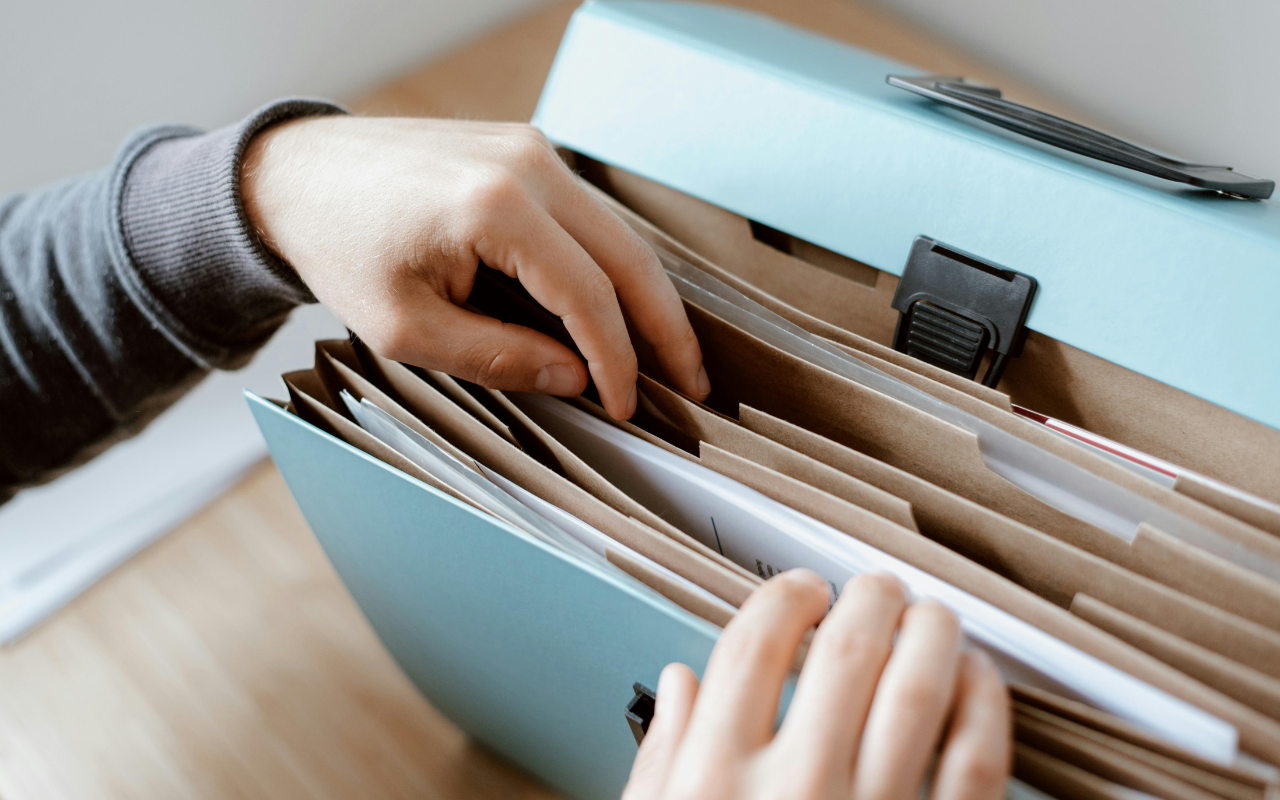Person searching through documents.