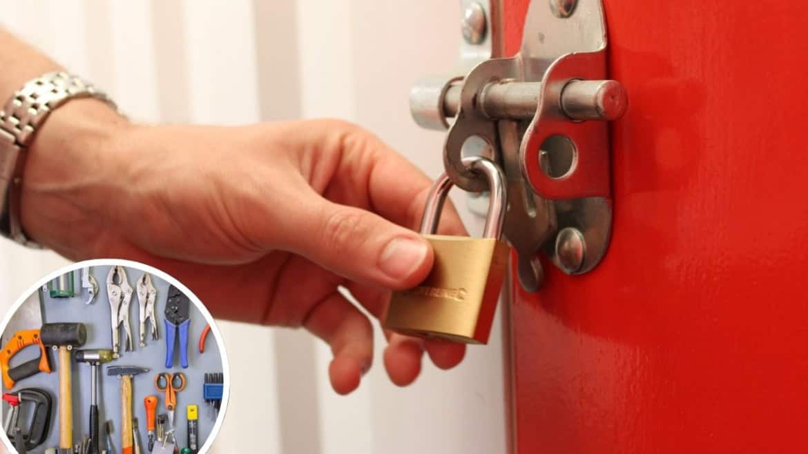 Hand holding a padlock on a storage unit