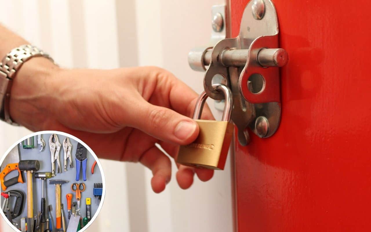 Hand holding a padlock on a storage unit